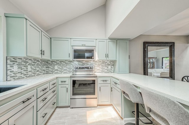 7047 N Teilman Ave Unit 102, Fresno, CA 93711 - kitchen with appliances with stainless steel finishes, light countertops, decorative backsplash, and lofted ceiling