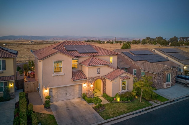 4367 Salem Ln, Clovis, CA 93619 - mediterranean / spanish-style house featuring stucco siding, a tile roof, an attached garage, driveway, and solar panels