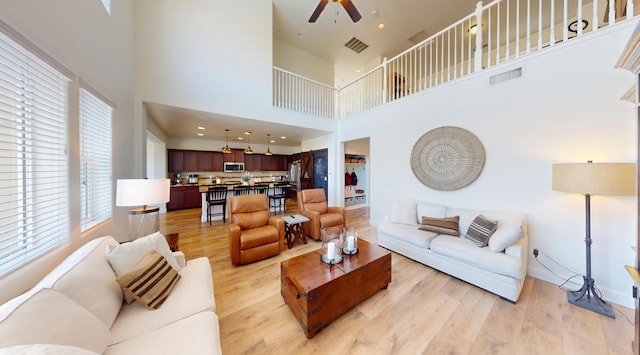 4367 Salem Ln, Clovis, CA 93619 - living room with a ceiling fan, light wood-style floors, and a high ceiling