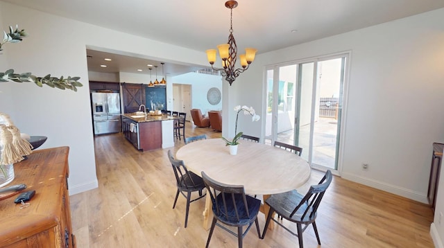 4367 Salem Ln, Clovis, CA 93619 - dining room featuring a chandelier and light wood-style flooring