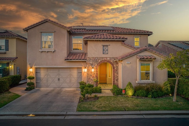 4367 Salem Ln, Clovis, CA 93619 - mediterranean / spanish house with a tile roof, stucco siding, driveway, roof mounted solar panels, and an attached garage