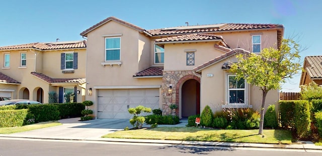 4367 Salem Ln, Clovis, CA 93619 - mediterranean / spanish home featuring a garage, a tile roof, driveway, and stucco siding