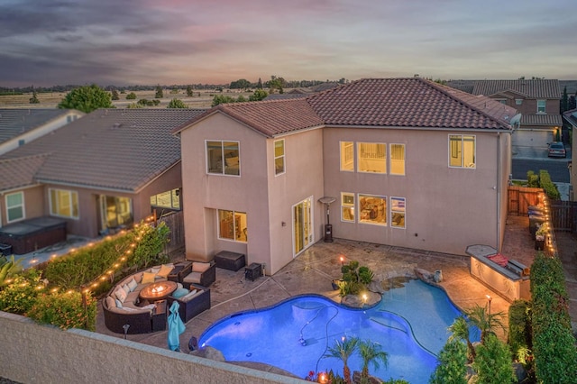 4367 Salem Ln, Clovis, CA 93619 - back of property with a fire pit, a jacuzzi, a fenced backyard, a patio area, and stucco siding