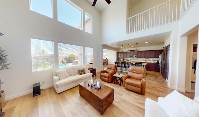 4367 Salem Ln, Clovis, CA 93619 - living room featuring a ceiling fan, light wood-style floors, and a high ceiling