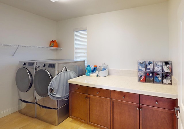 4367 Salem Ln, Clovis, CA 93619 - laundry area featuring washing machine and clothes dryer, cabinet space, and light wood-style floors