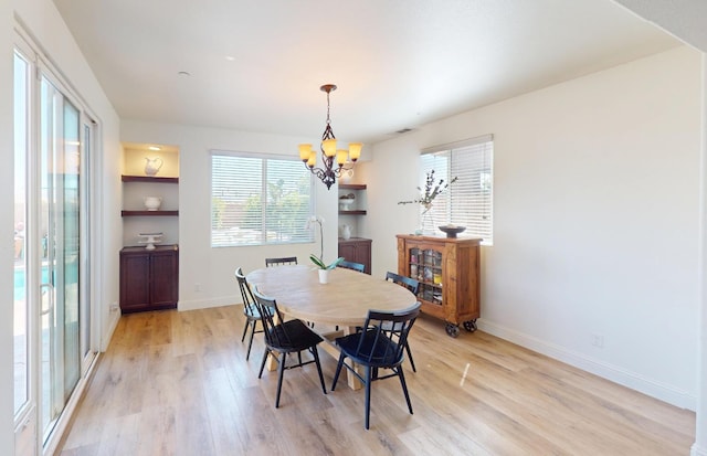 4367 Salem Ln, Clovis, CA 93619 - dining area featuring light wood-type flooring, a chandelier, and plenty of natural light