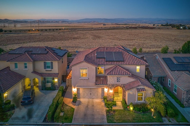 4367 Salem Ln, Clovis, CA 93619 - view of front of home featuring an attached garage, stucco siding, concrete driveway, solar panels, and a mountain view