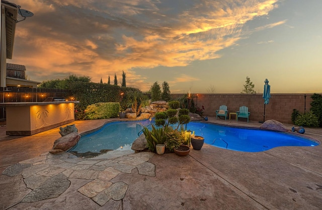 4367 Salem Ln, Clovis, CA 93619 - pool at dusk featuring a patio and a fenced backyard