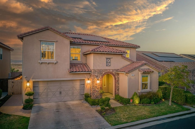 4367 Salem Ln, Clovis, CA 93619 - mediterranean / spanish-style house featuring a tiled roof, stucco siding, an attached garage, roof mounted solar panels, and driveway