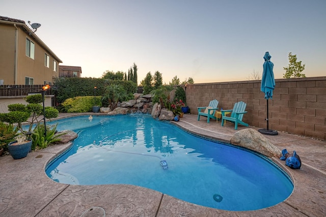 4367 Salem Ln, Clovis, CA 93619 - pool at dusk with a fenced backyard and a patio area