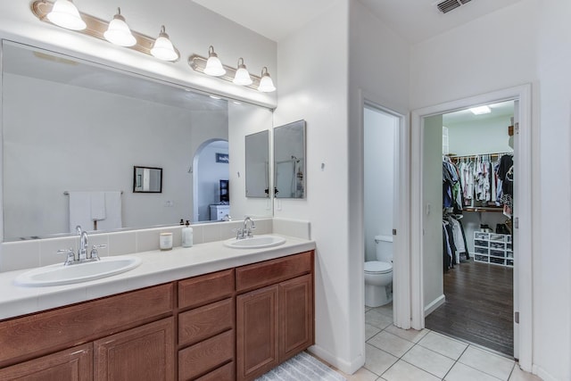 7230 E Dayton Ave, Fresno, CA 93737 - full bath featuring tile patterned floors, double vanity, and a spacious closet