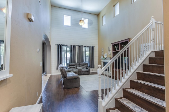 7230 E Dayton Ave, Fresno, CA 93737 - entryway featuring a towering ceiling, arched walkways, wood finished floors, and stairs