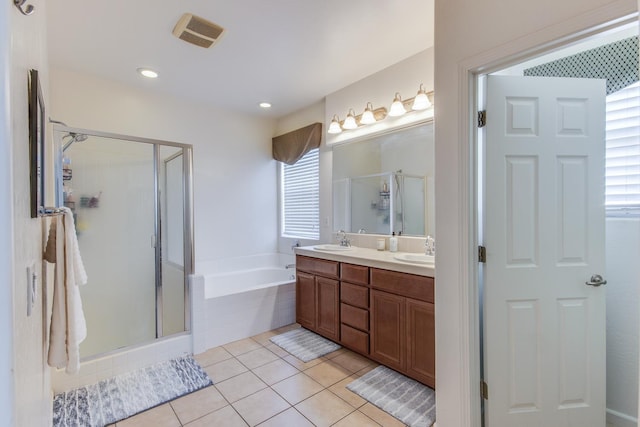 7230 E Dayton Ave, Fresno, CA 93737 - bathroom featuring healthy amount of natural light, double vanity, a bath, and a stall shower
