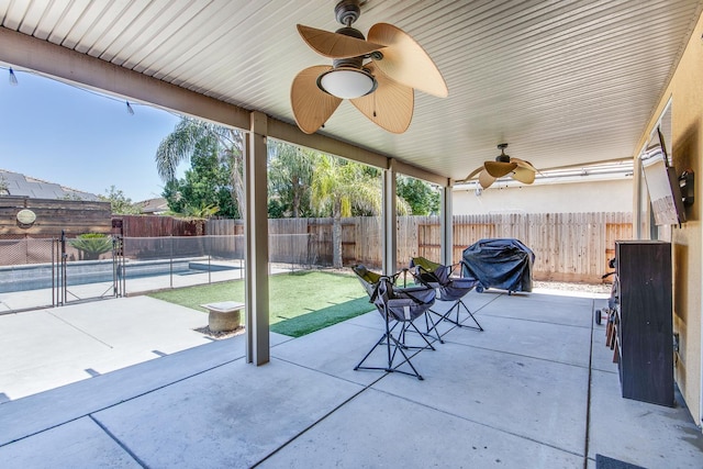 7230 E Dayton Ave, Fresno, CA 93737 - fenced backyard with a patio, a grill, and a ceiling fan