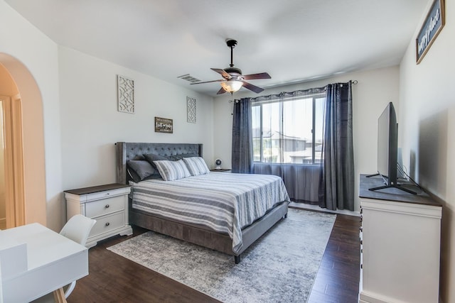 7230 E Dayton Ave, Fresno, CA 93737 - bedroom with dark wood finished floors, arched walkways, and a ceiling fan