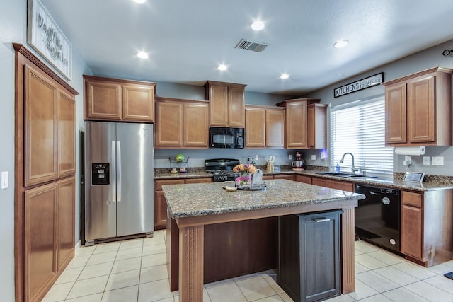 7230 E Dayton Ave, Fresno, CA 93737 - kitchen featuring black appliances, stone countertops, a center island, brown cabinetry, and recessed lighting