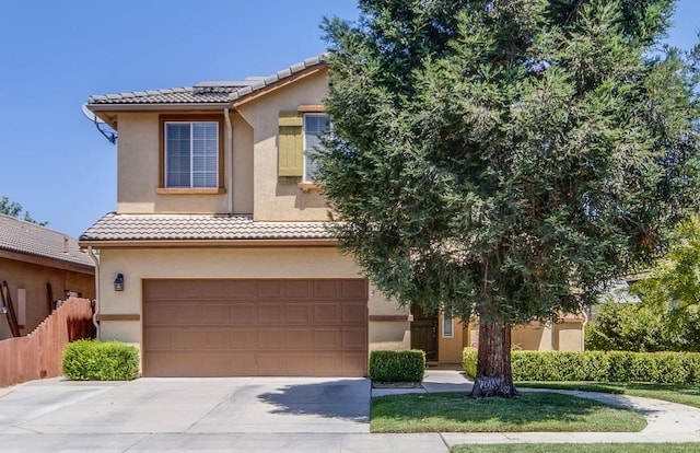 7230 E Dayton Ave, Fresno, CA 93737 - view of front of property featuring an attached garage, stucco siding, a tiled roof, and concrete driveway