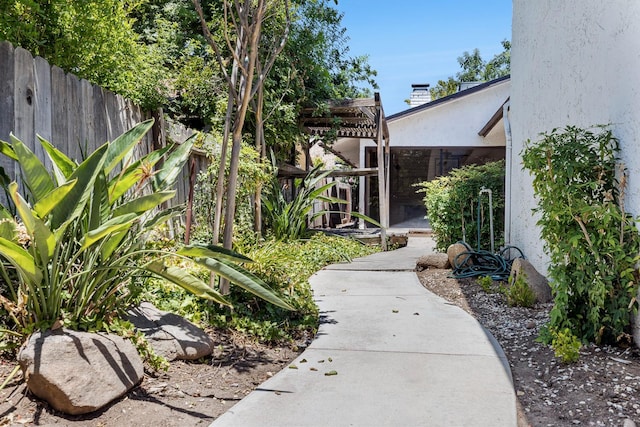 2076 W Calimyrna Ave Unit 102, Fresno, CA 93711 - fenced backyard featuring a pergola