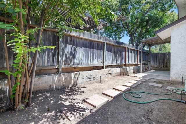 2076 W Calimyrna Ave Unit 102, Fresno, CA 93711 - fenced backyard with a patio