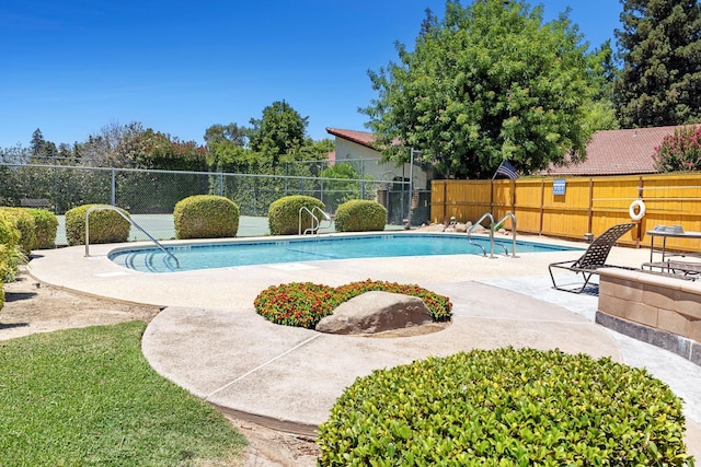 2076 W Calimyrna Ave Unit 102, Fresno, CA 93711 - view of swimming pool with a patio