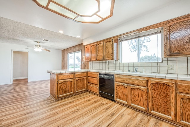 11016 E S Ave, Selma, CA 93662 - kitchen with dishwasher, a peninsula, brown cabinetry, light wood-style floors, and recessed lighting