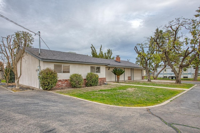 11016 E S Ave, Selma, CA 93662 - view of front of house with a garage, driveway, a front lawn, a chimney, and stucco siding