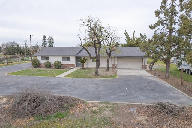 11016 E S Ave, Selma, CA 93662 - ranch-style home featuring driveway, brick siding, an attached garage, and a front lawn