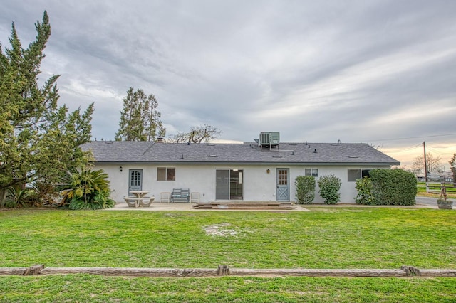 11016 E S Ave, Selma, CA 93662 - rear view of house with stucco siding, a patio, and a yard