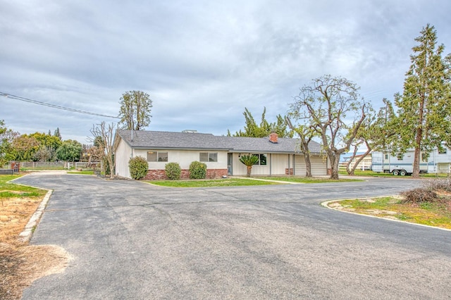 11016 E S Ave, Selma, CA 93662 - single story home with asphalt driveway, a chimney, and brick siding