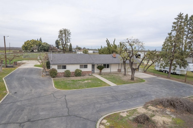 11016 E S Ave, Selma, CA 93662 - ranch-style house featuring asphalt driveway, a front lawn, and roof with shingles