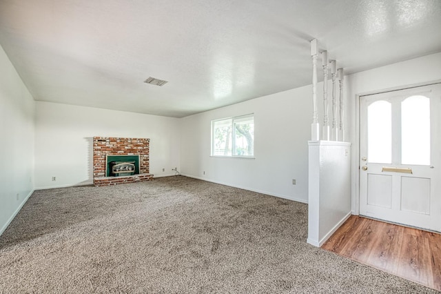 11016 E S Ave, Selma, CA 93662 - unfurnished living room featuring carpet flooring and a brick fireplace