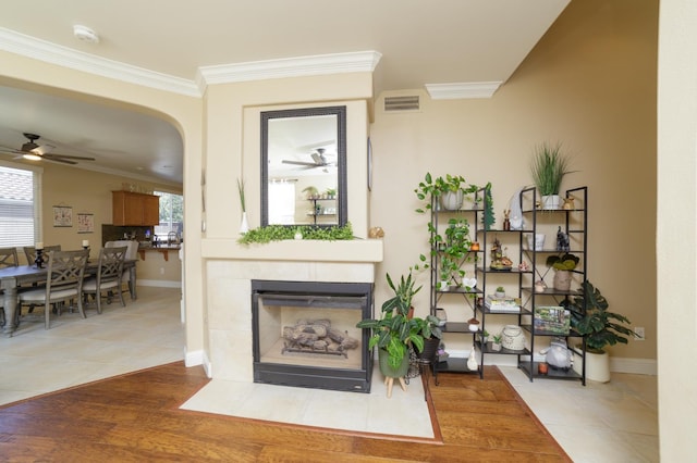 4001 W Fig Tree Ln, Fresno, CA 93722 - detailed view of ceiling fan, ornamental molding, a smoke detector, a tiled fireplace, and arched walkways