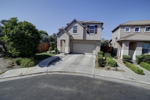 4001 W Fig Tree Ln, Fresno, CA 93722 - traditional-style home with concrete driveway, roof mounted solar panels, a garage, and stucco siding
