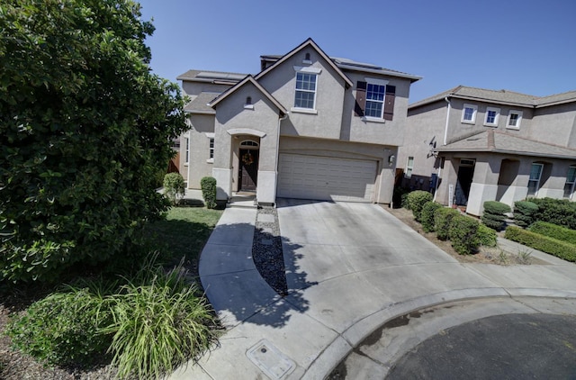 4001 W Fig Tree Ln, Fresno, CA 93722 - traditional-style house featuring stucco siding, solar panels, concrete driveway, and an attached garage