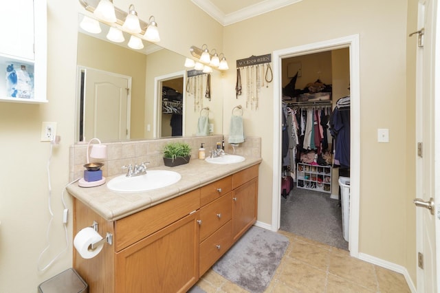 4001 W Fig Tree Ln, Fresno, CA 93722 - bathroom featuring double vanity, tasteful backsplash, ornamental molding, a walk in closet, and tile patterned floors