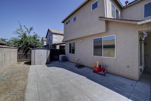 4001 W Fig Tree Ln, Fresno, CA 93722 - rear view of property featuring a shed, a patio area, a fenced backyard, and stucco siding
