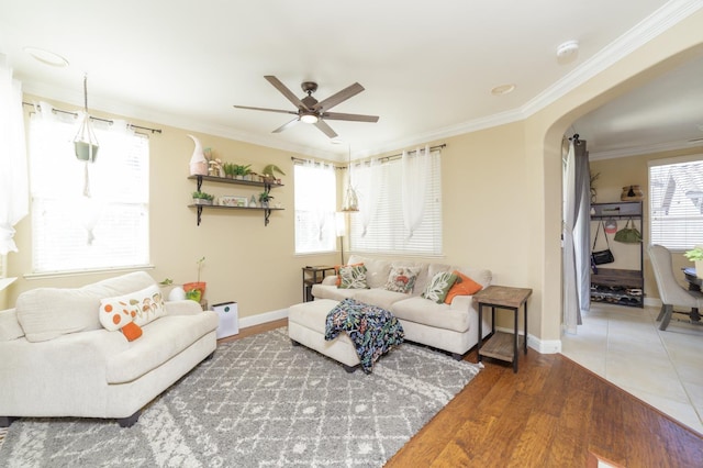 4001 W Fig Tree Ln, Fresno, CA 93722 - living room featuring crown molding, ceiling fan, arched walkways, and wood finished floors