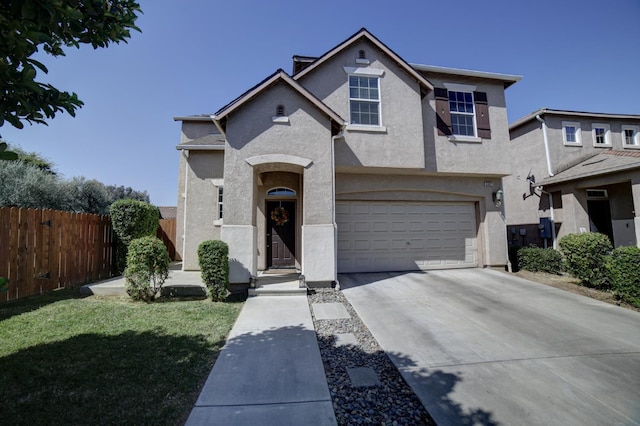 4001 W Fig Tree Ln, Fresno, CA 93722 - view of front of house with stucco siding, driveway, and a garage