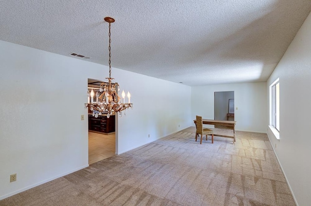 41151 Fig Grove Cir, Madera, CA 93636 - dining space with carpet, a chandelier, and a textured ceiling