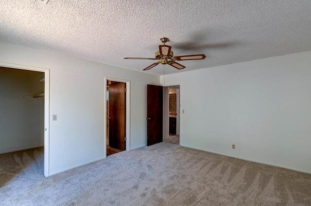 41151 Fig Grove Cir, Madera, CA 93636 - unfurnished bedroom featuring a spacious closet, carpet flooring, ceiling fan, and a textured ceiling