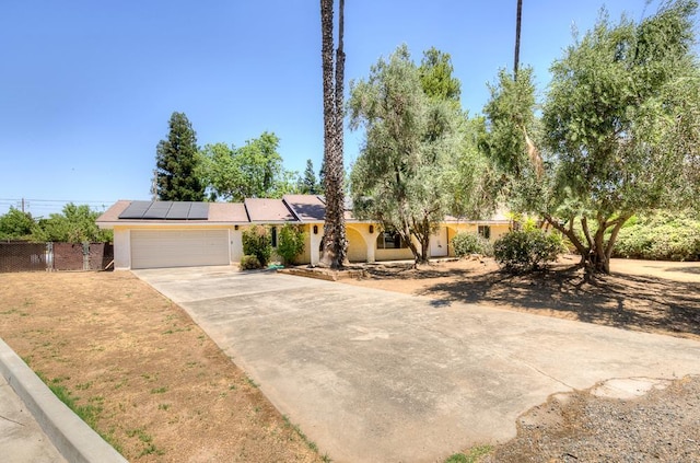 41151 Fig Grove Cir, Madera, CA 93636 - view of front of home with a garage, driveway, solar panels, and stucco siding