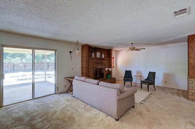 41151 Fig Grove Cir, Madera, CA 93636 - living room featuring a fireplace, a textured ceiling, carpet flooring, and a ceiling fan