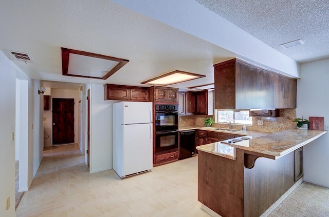 41151 Fig Grove Cir, Madera, CA 93636 - kitchen featuring black appliances, a peninsula, a textured ceiling, decorative backsplash, and a kitchen breakfast bar