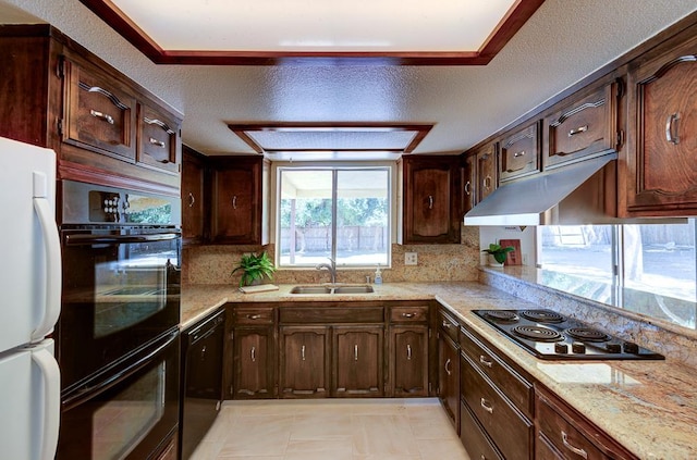 41151 Fig Grove Cir, Madera, CA 93636 - kitchen featuring black appliances, backsplash, light stone counters, dark brown cabinets, and a textured ceiling
