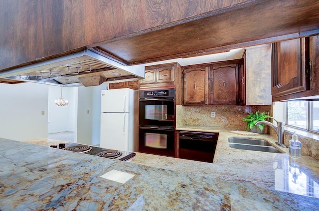 41151 Fig Grove Cir, Madera, CA 93636 - kitchen with black appliances, light stone countertops, and backsplash