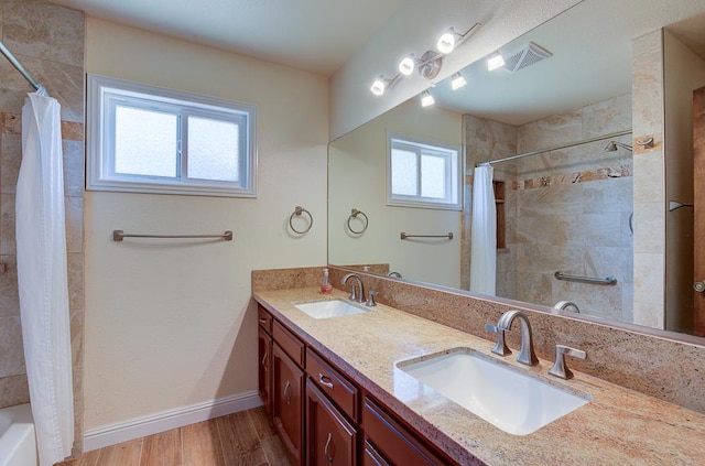 41151 Fig Grove Cir, Madera, CA 93636 - bathroom with double vanity, wood finished floors, and shower / bathtub combination with curtain