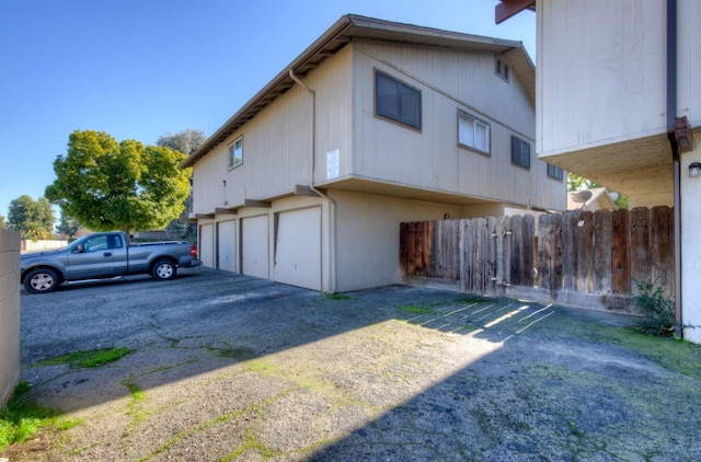 605 W Ashlan Ave, Clovis, CA 93612 - view of property exterior with a garage and asphalt driveway