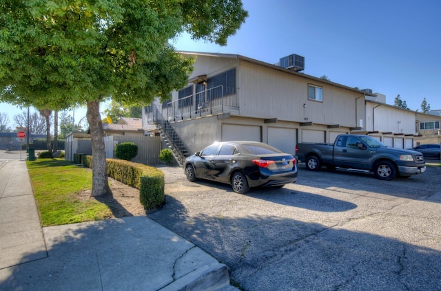 605 W Ashlan Ave, Clovis, CA 93612 - townhome / multi-family property featuring stairway, driveway, and an attached garage