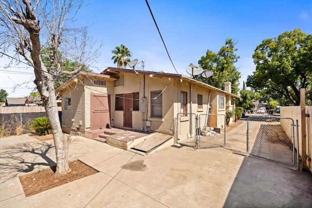 3334 E Montecito Ave, Fresno, CA 93702 - view of front facade with a gate, stucco siding, a chimney, and a patio area
