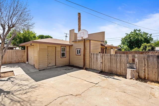 3334 E Montecito Ave, Fresno, CA 93702 - rear view of house with driveway and a detached garage